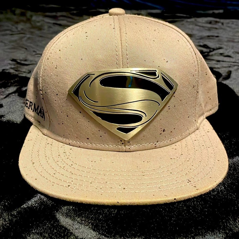 Metal embroidery of the super man logo with Superman written on the side